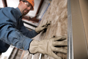 Expert Insulation installing fiberglass insulation