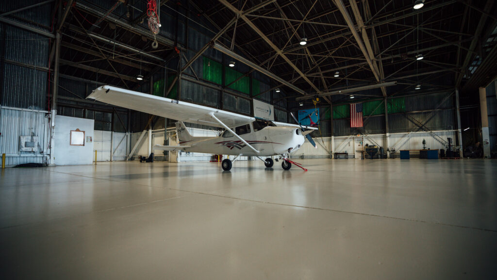 commercial-polyurea-flooring An airplane hanger with new polyurea flooring